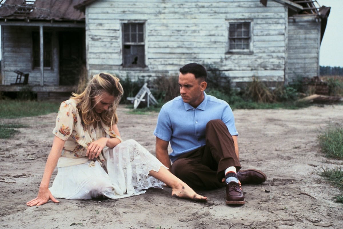 Robin Wright as Jenny Curran sits barefoot beside Tom Hanks as Forrest Gump, her undone appearance and lack of shoes underscoring Jenny’s vulnerability and free-spirited nature