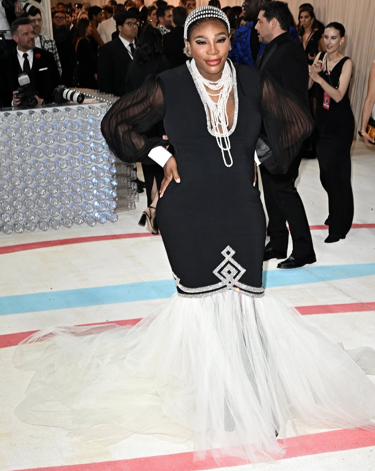 Serena Williams cradled her baby bump while donning a custom Gucci gown that hugged her hourglass figure at the 2023 Met Gala Celebrating "Karl Lagerfeld: A Line Of Beauty"