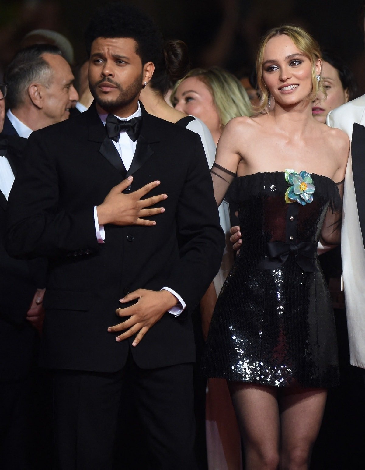 Abel Tesfaye in a bespoke Loewe tuxedo and Lily-Rose Depp in a Chanel Fall 1994 embellished bustier dress with a blue camellia accent