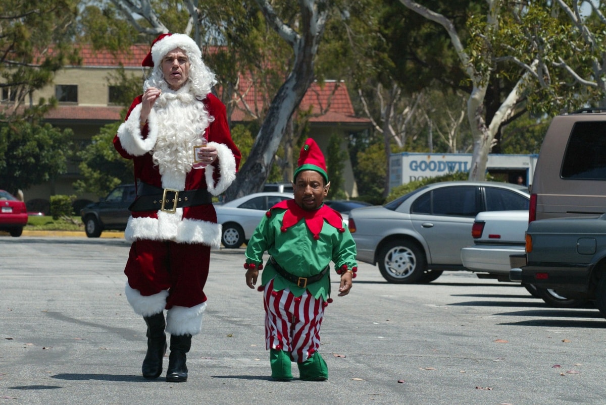 Billy Bob Thornton and Tony Cox star as a criminal duo posing as Santa and his elf in the dark comedy Bad Santa (2003)