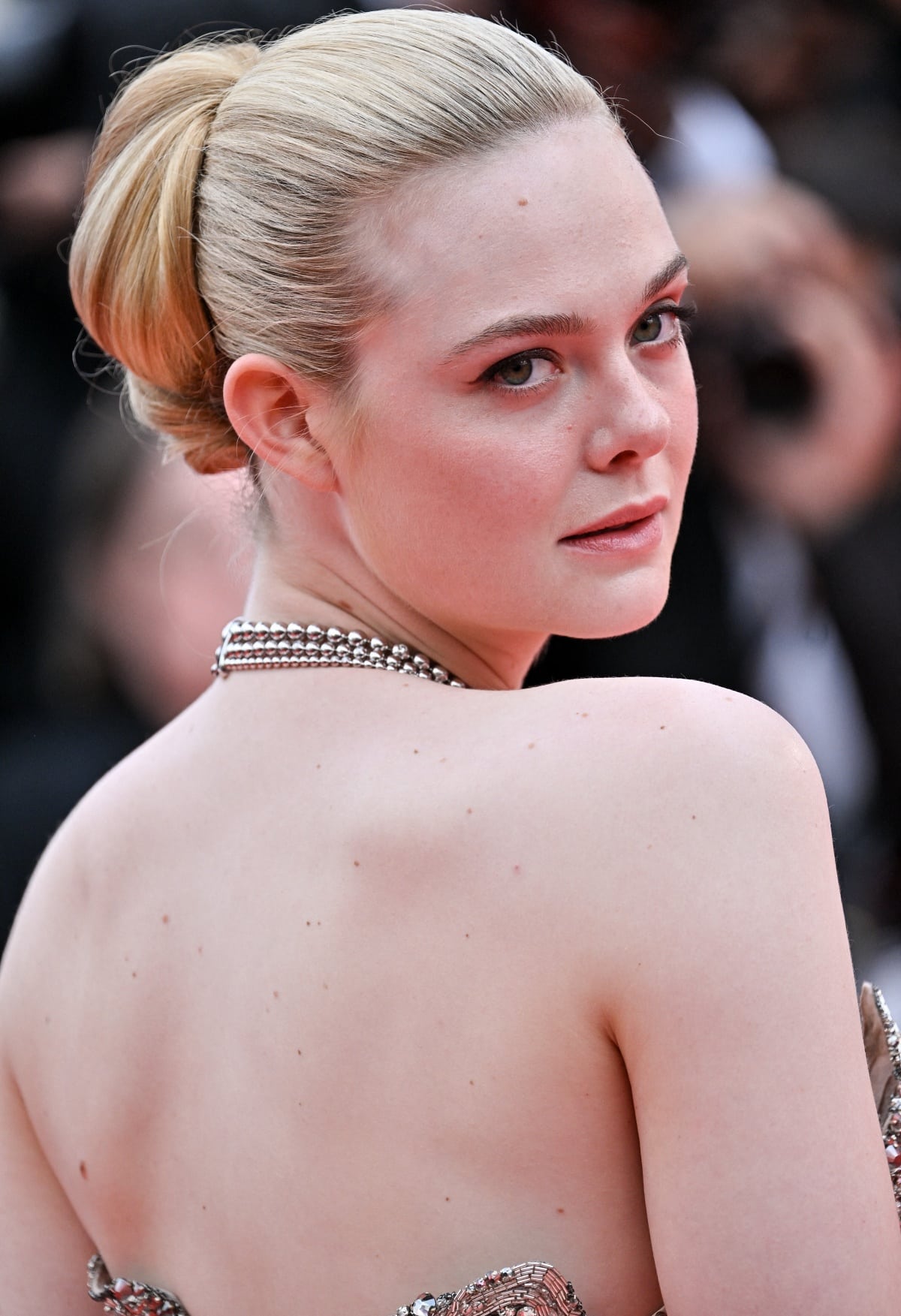 Elle Fanning’s hair was swept up in a chic updo to show off her gorgeous face and flawless beauty look