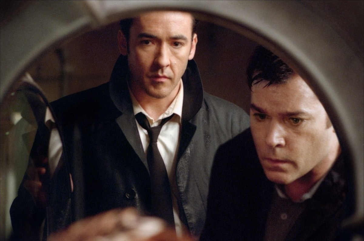 John Cusack and Ray Liotta investigate a mystery in a tense scene from the 2003 psychological thriller Identity