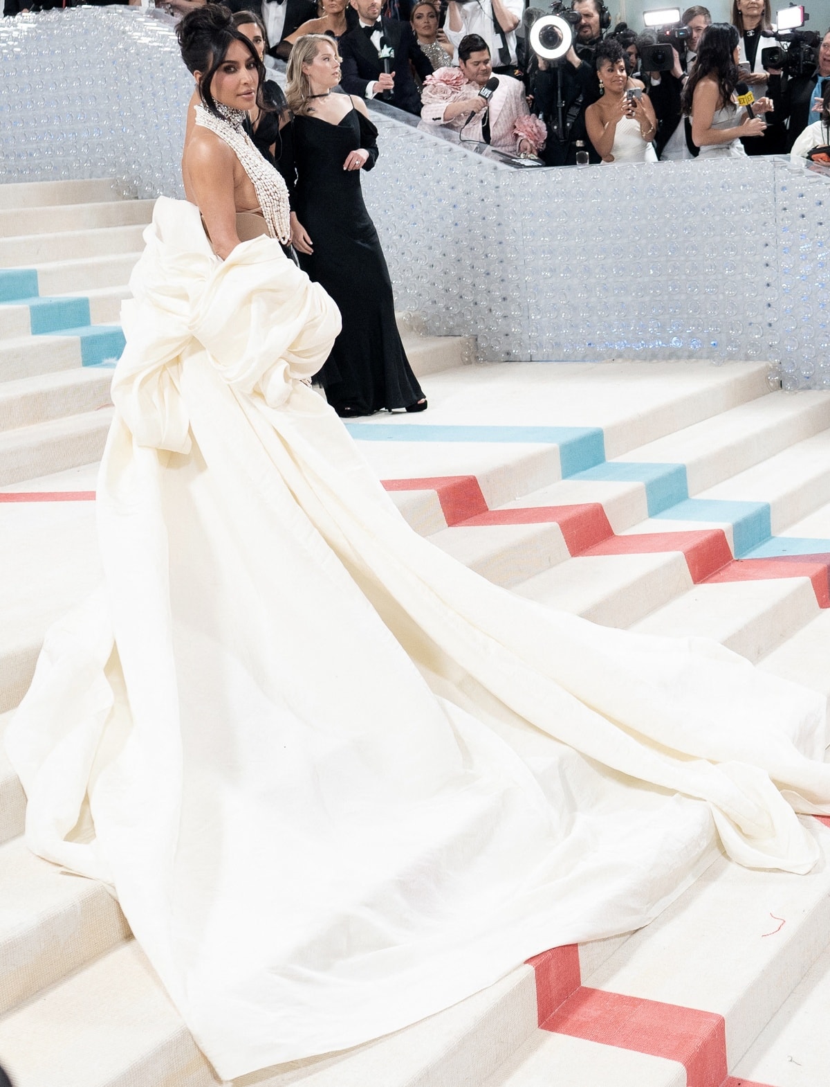 Kim Kardashian wore a custom Schiaparelli Haute Couture look complete with a dramatic white stole