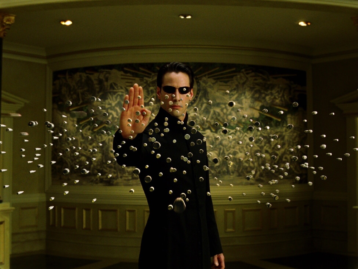Keanu Reeves as Neo stops a barrage of bullets in a memorable action sequence from The Matrix Reloaded (2003)