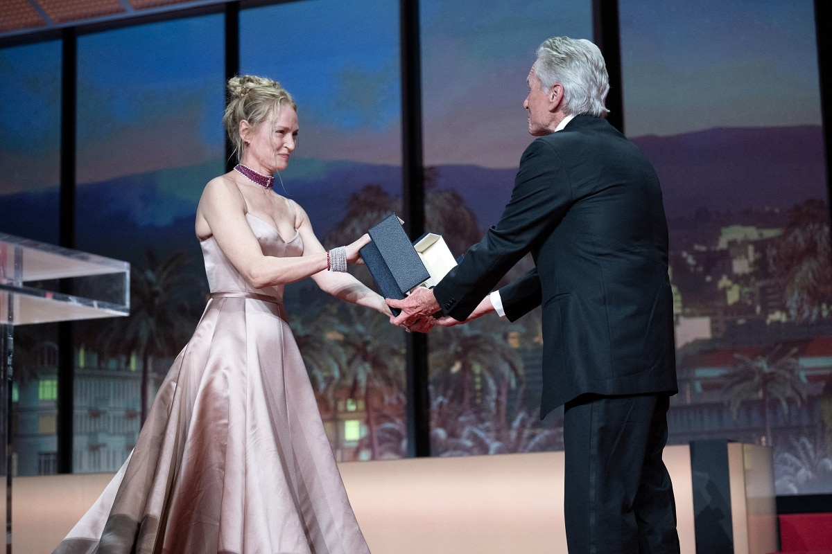 Uma Thurman presenting the Honorary Palme d’Or to Michael Douglas during the 76th Cannes Film Festival