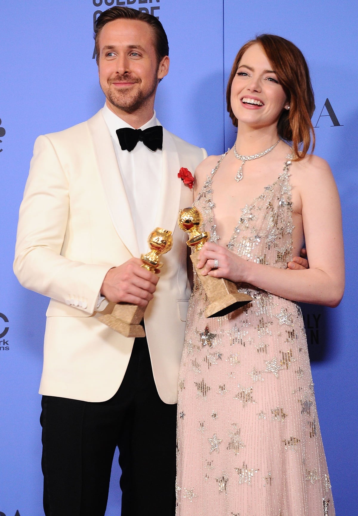 Actor Ryan Gosling (L) and actress Emma Stone pose with their awards in the press room during the 74th Annual Golden Globe Awards