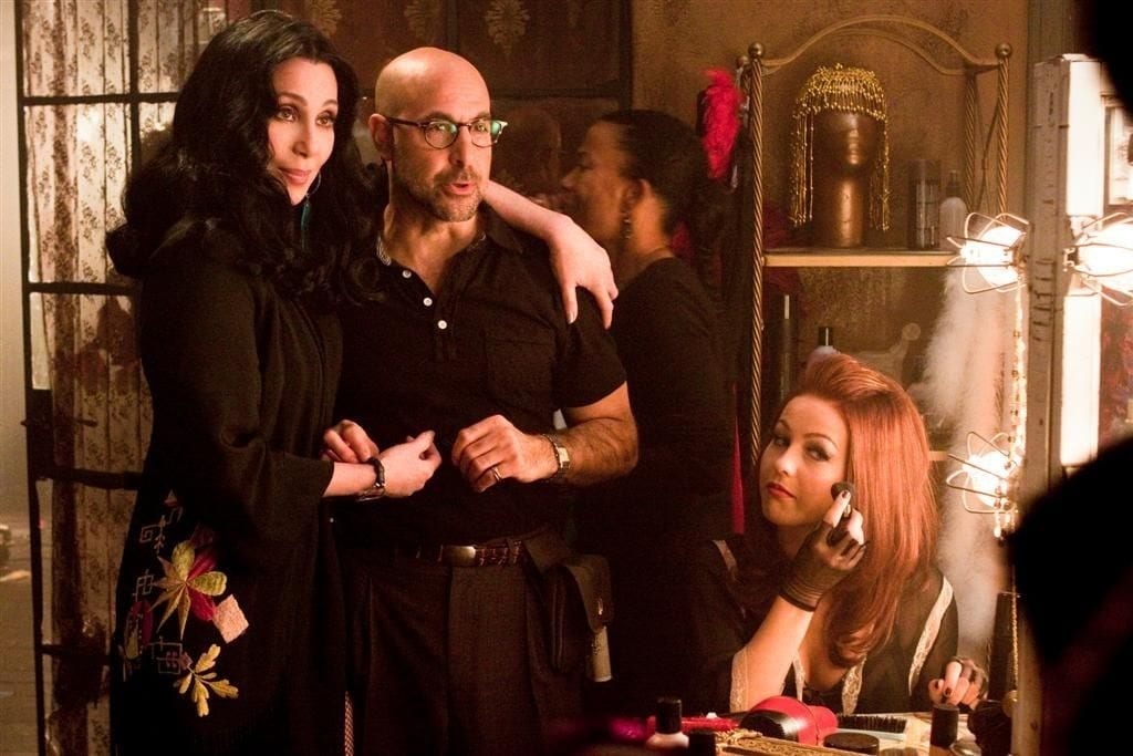 Cher portrayed Tess, the strong yet fair owner of a Los Angeles burlesque club; Julianne Hough portrayed Georgia, an aspiring dancer with dreams of success in the burlesque world; and Stanley Tucci portrayed Sean, Tess's supportive and charismatic manager who assisted Georgia in pursuing her ambitions.