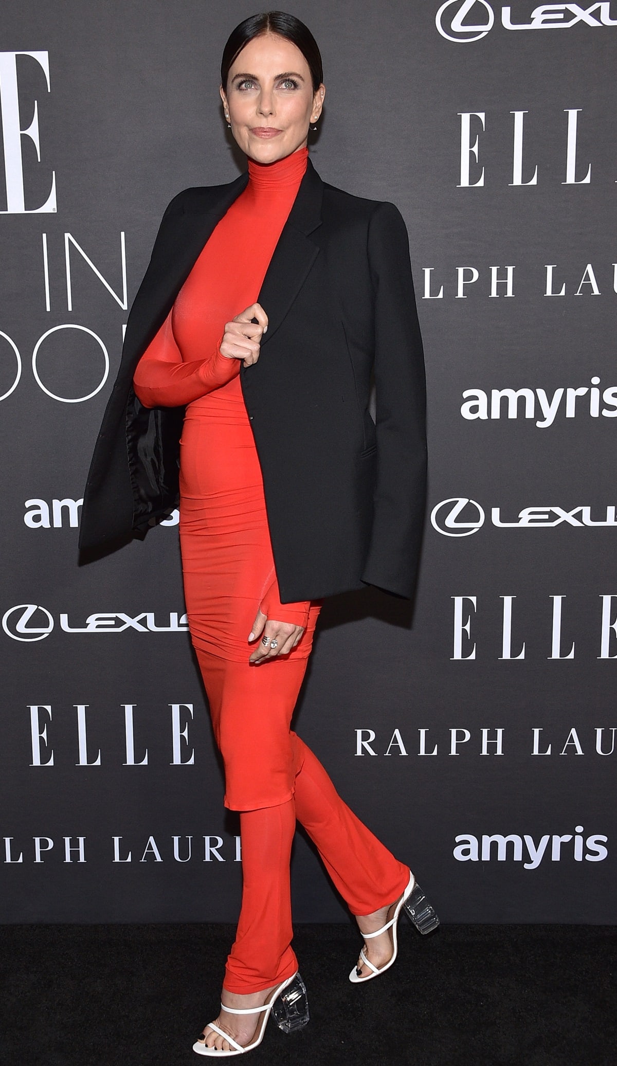 Charlize Theron donning a vibrant red Alaia outfit from the brand's Spring Summer 2023 collection at the 29th annual ELLE Women in Hollywood celebration