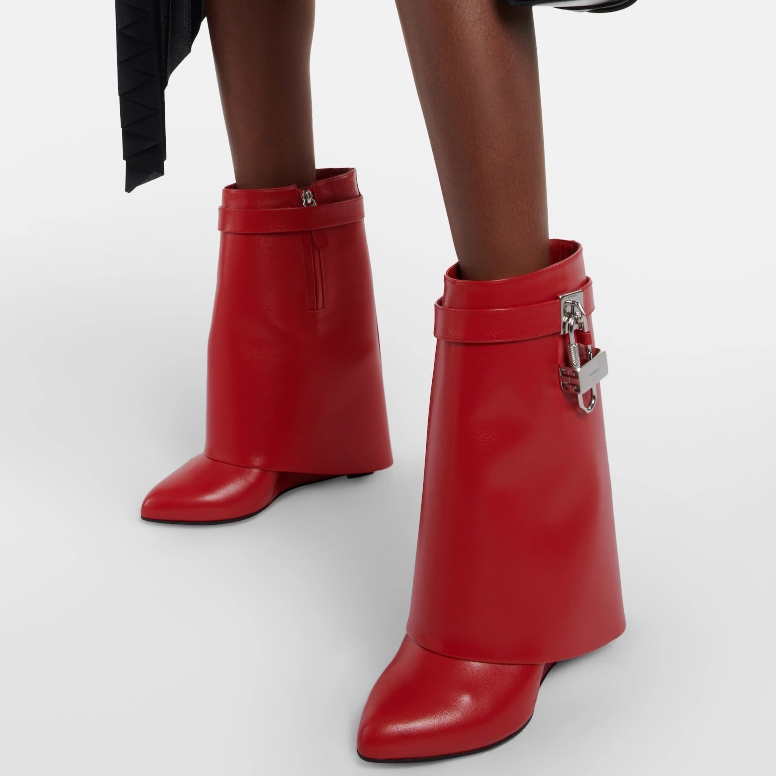 Crafted in Italy from polished calfskin, Givenchy's iconic Shark Lock ankle boots showcase fold-over shafts and boast high wedge heels for an added touch of allure