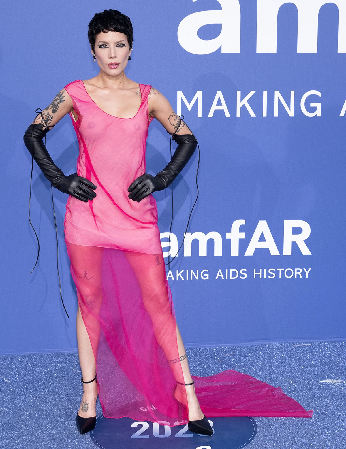 Halsey bares her nipples in a see-through pink Givenchy gown with black leather opera gloves for a rebellious finish