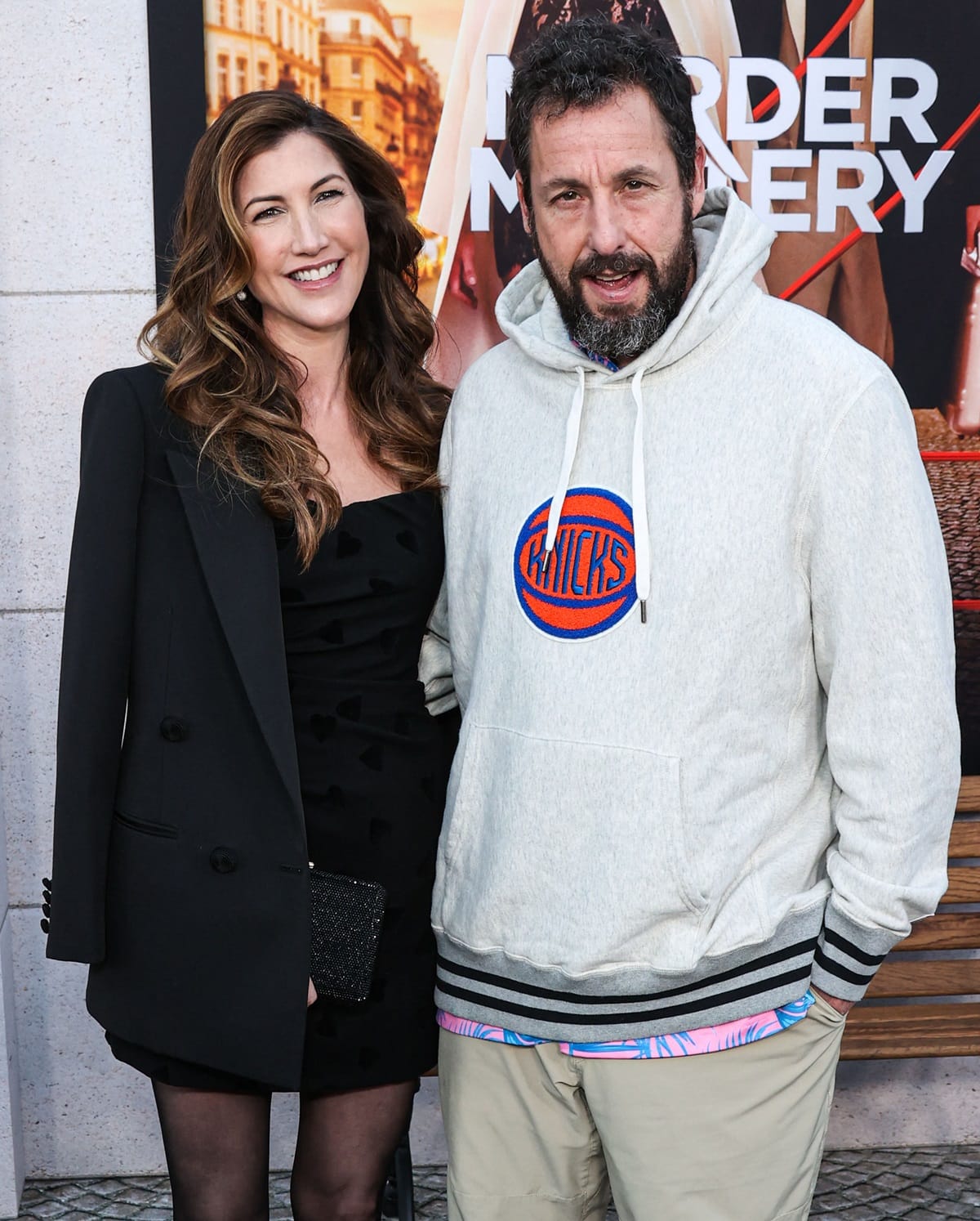 Jackie Sandler, who is 5'9" (1.75 m) tall, posed with her slightly taller husband Adam Sandler, who is 5'9 ¾" (177.2 cm) tall, at the Los Angeles Premiere Of Netflix's "Murder Mystery 2"