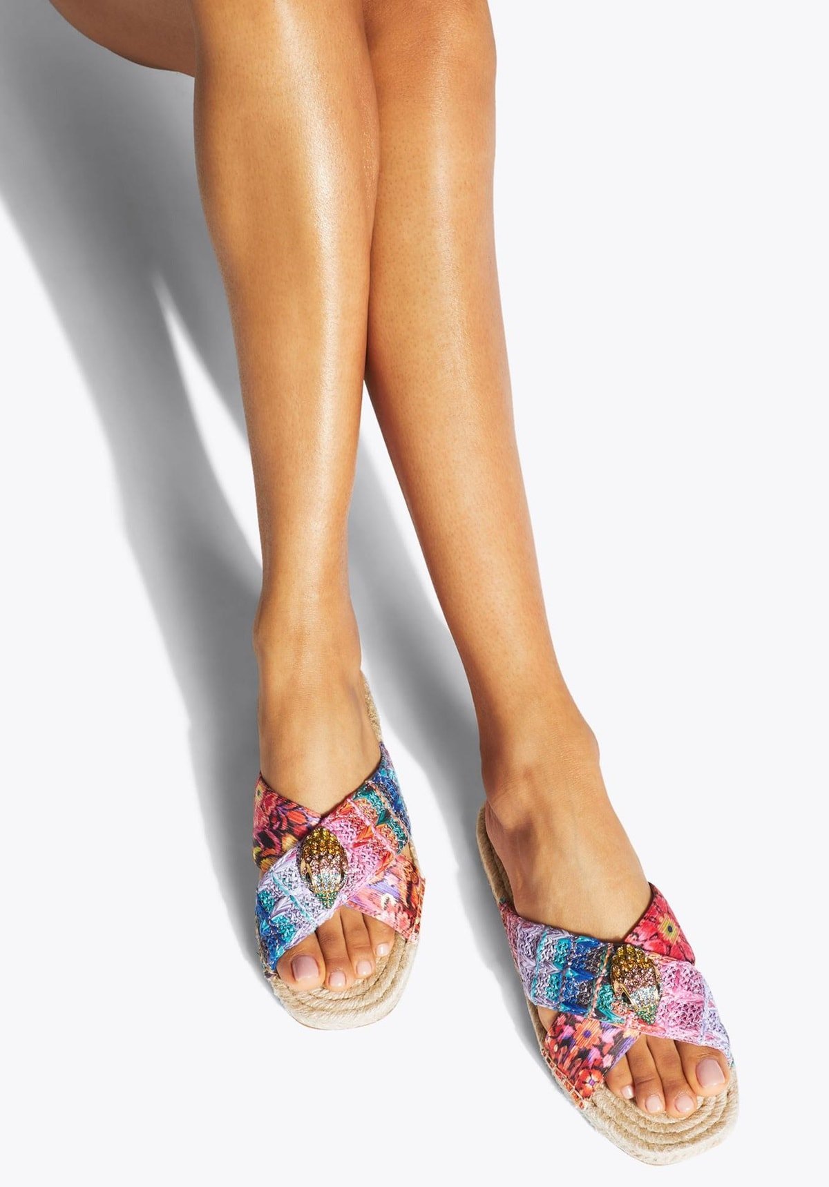As in all the pieces in the collection, these espadrilles feature a bespoke print created by cult favorite designer Matthew Williamson and boast of rainbow and fuchsia floral motif crossed straps and a gold eagle head with rainbow crystals on each sandal
