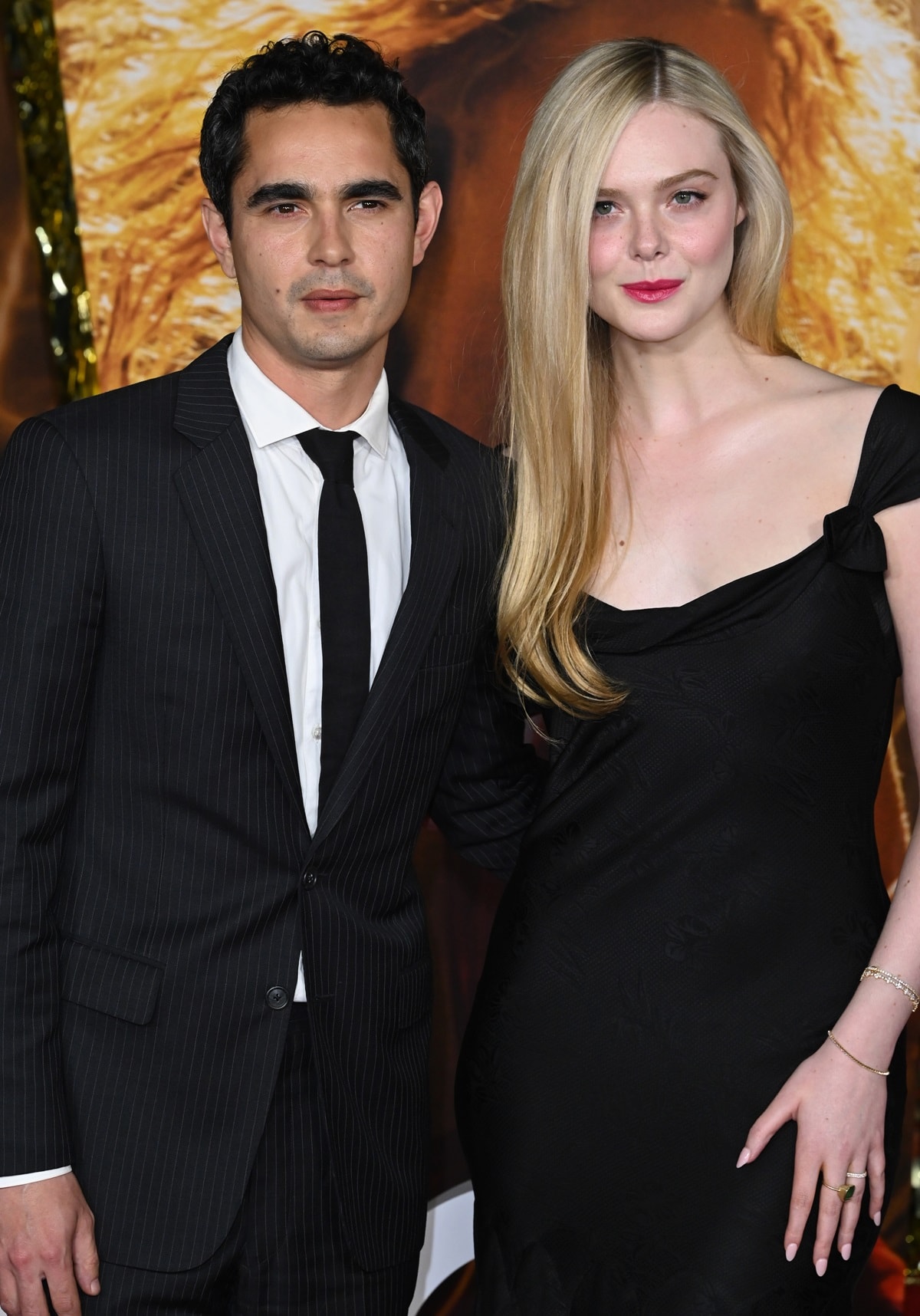 Elle Fanning, with a height of 5ft 8 ½ (174 cm), is slightly shorter than Max Minghella, who measures 5ft 9 (175.3 cm), but often looks taller when wearing high heels