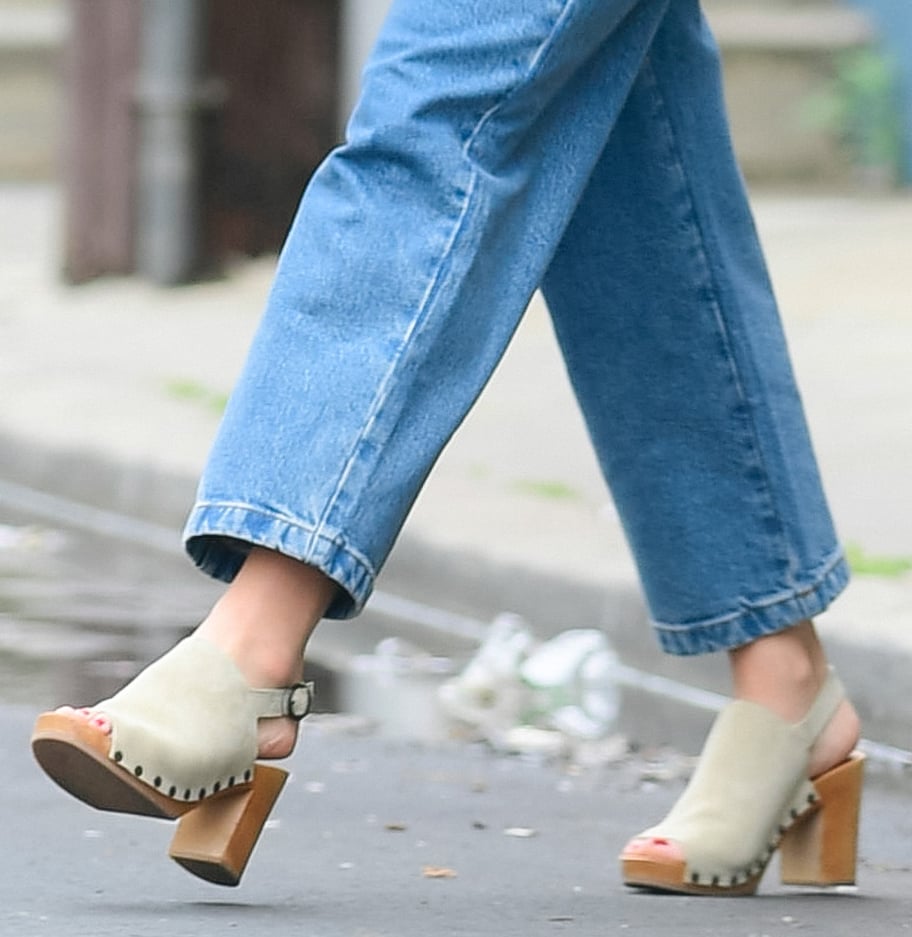 Olivia Wilde pairs her denim jumpsuit with high-heeled slingback clogs by Sezane