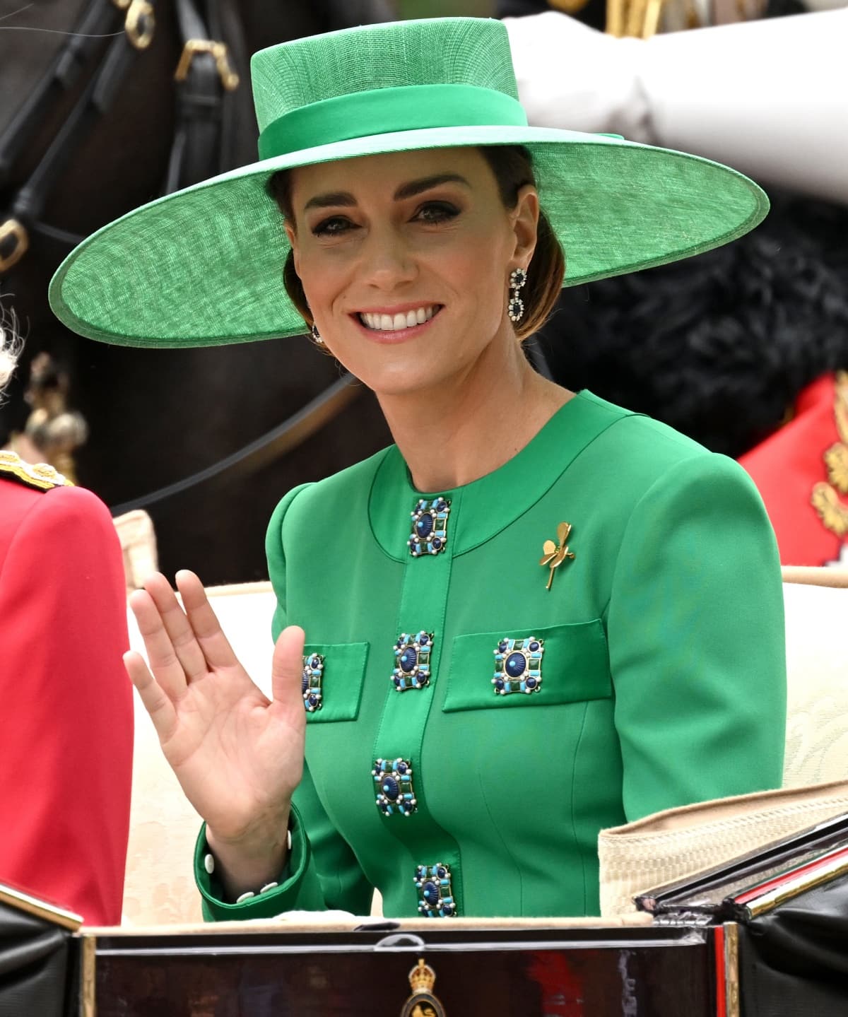 Catherine, Princess of Wales wearing a sophisticated green Andrew GN look with a matching green wide-brimmed hat by Philip Treacy