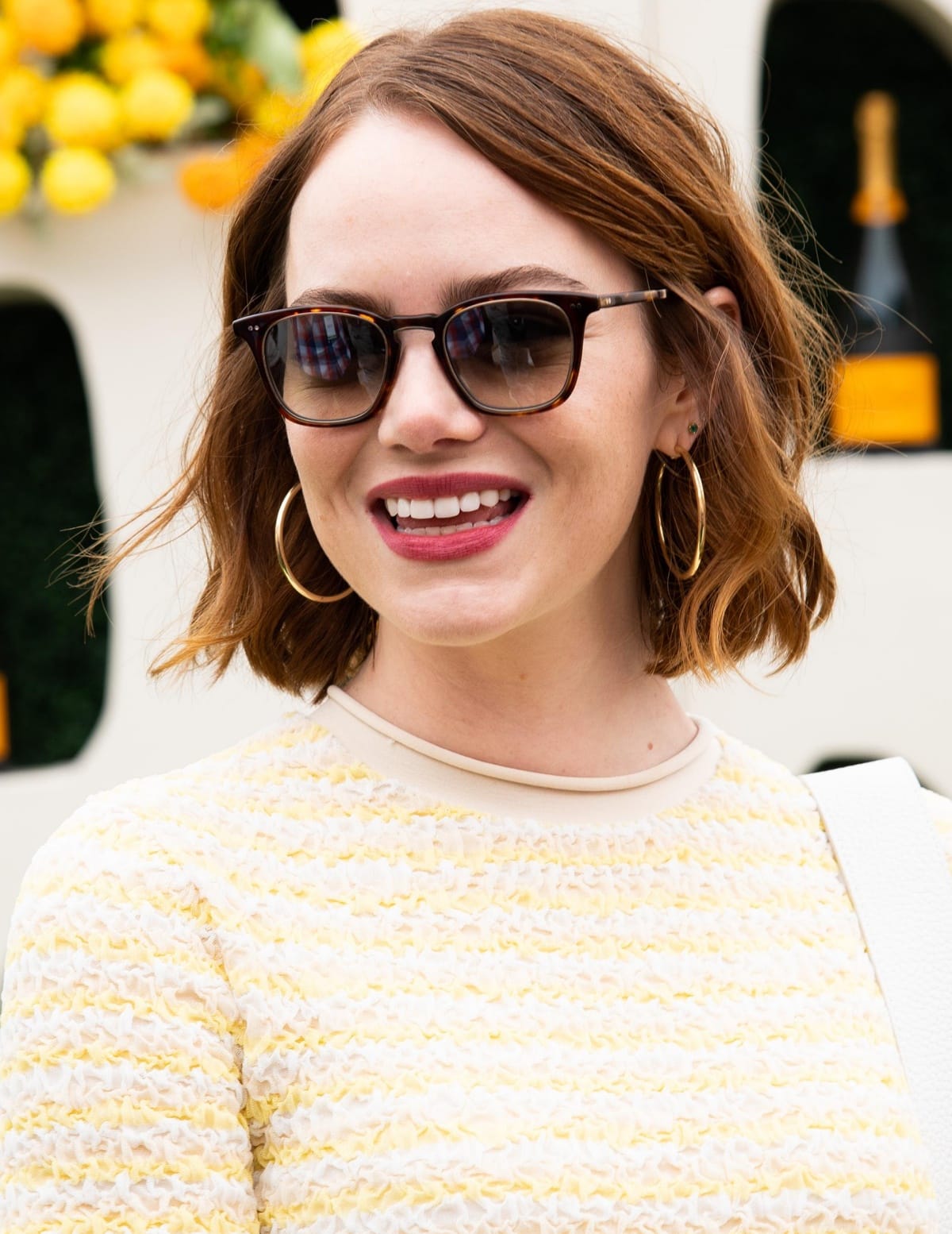 Emma Stone accessorized with Leight Getty tortoiseshell sunglasses and Melinda Maria Kendall 2 hoop earrings