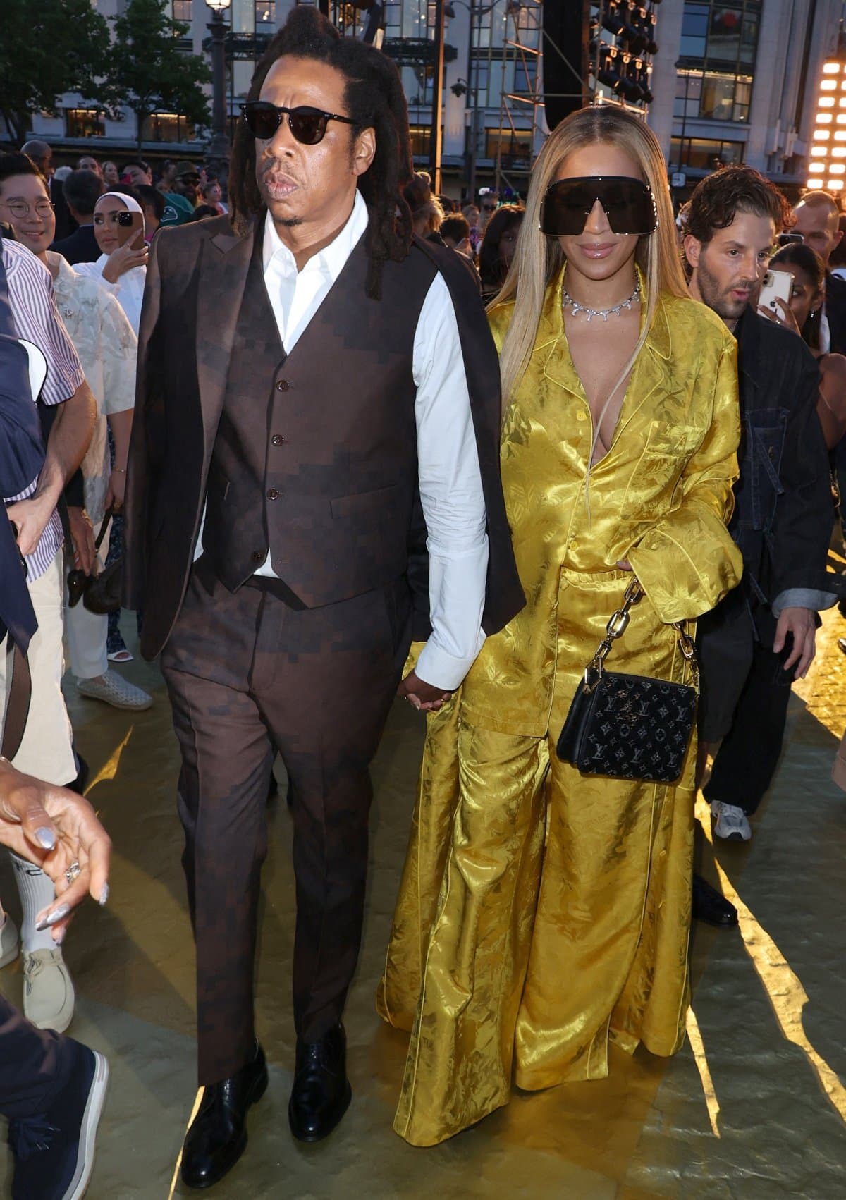 Jay-Z, always by Beyonce’s side, looking dapper in a custom Louis Vuitton suit styled with round sunglasses and glossy black leather oxfords