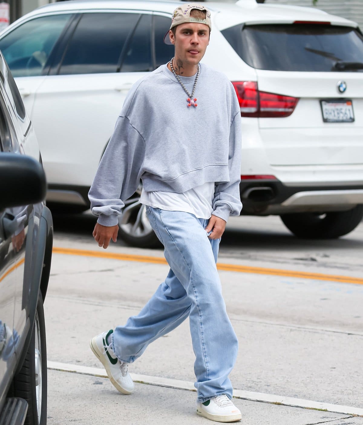Justin Bieber stuck to his casual style in baggy clothes with sneakers and a backwards baseball cap