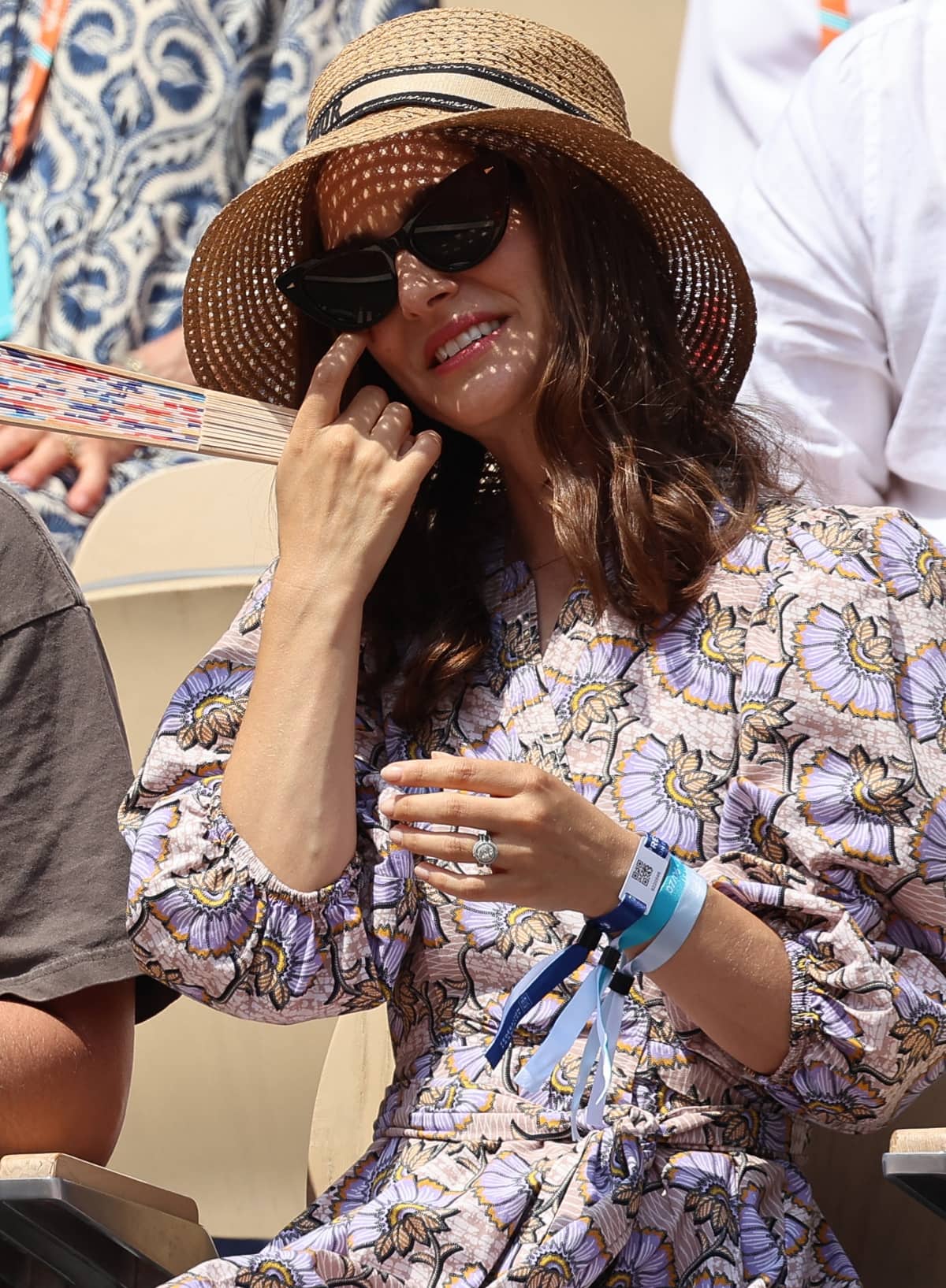 Natalie Portman wearing a Dior wide-brim hat and flashing both her engagement ring and wedding band