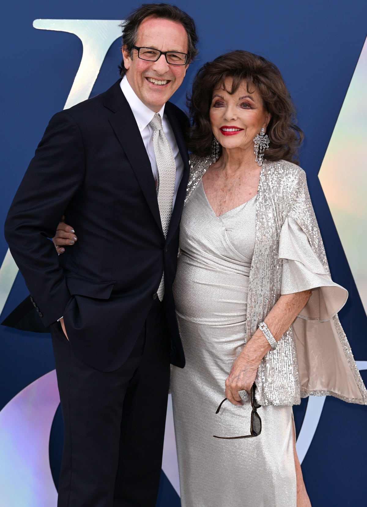 Percy Gibson and Dame Joan Collins showcasing their enduring partnership and long-lasting marriage