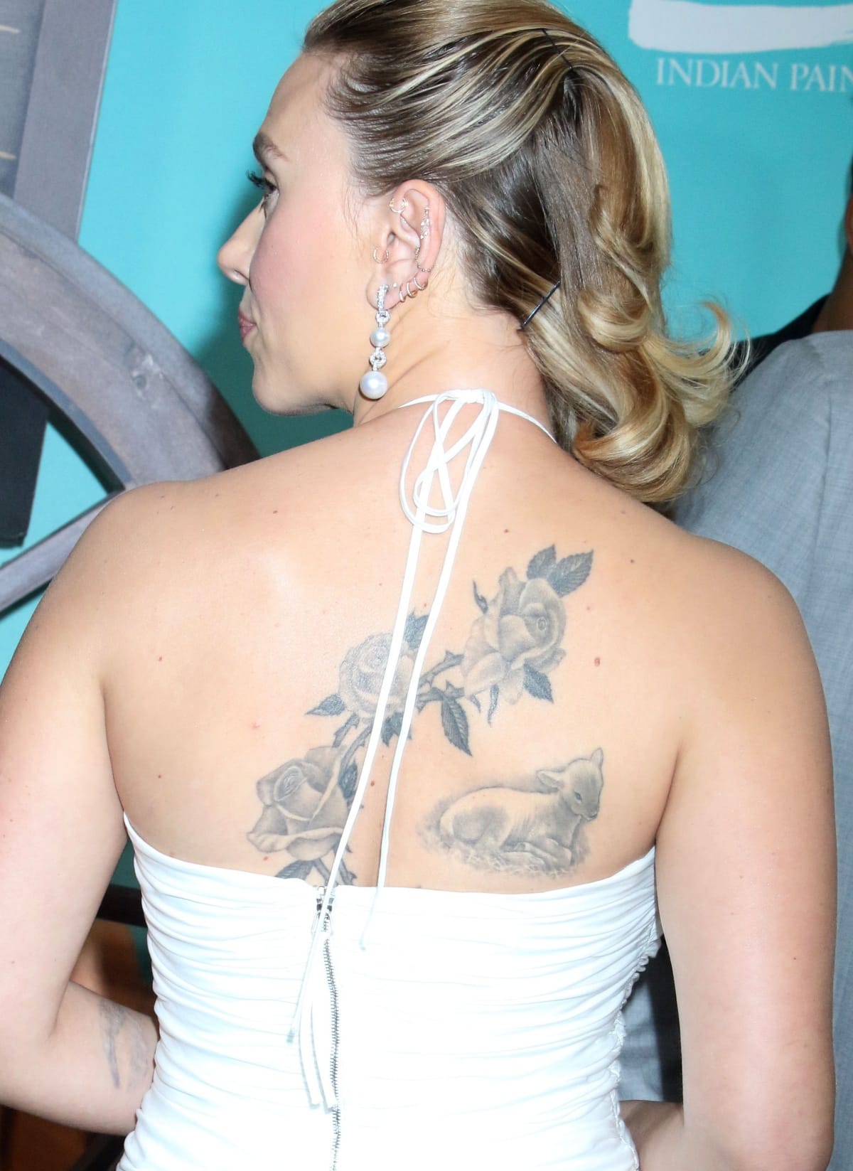 The open-back design of Scarlett Johansson’s dress allowed glimpses of her flower tattoos