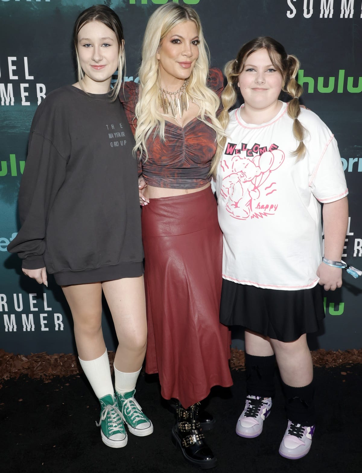 Stella and Hattie McDermott keeping it casual in a sweatshirt and graphic tee, respectively, with high socks and sneakers