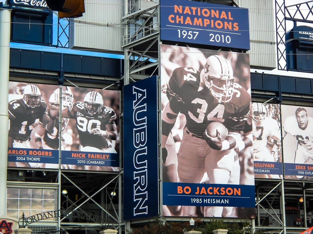 A poster featuring legendary student-athlete Bo Jackson, a Heisman trophy winner and former player for the Auburn University Tigers War Eagle SEC NCAA college football team, displayed on the exterior of Jordan-Hare Stadium, an American football stadium in Auburn, Alabama, on the campus of Auburn University