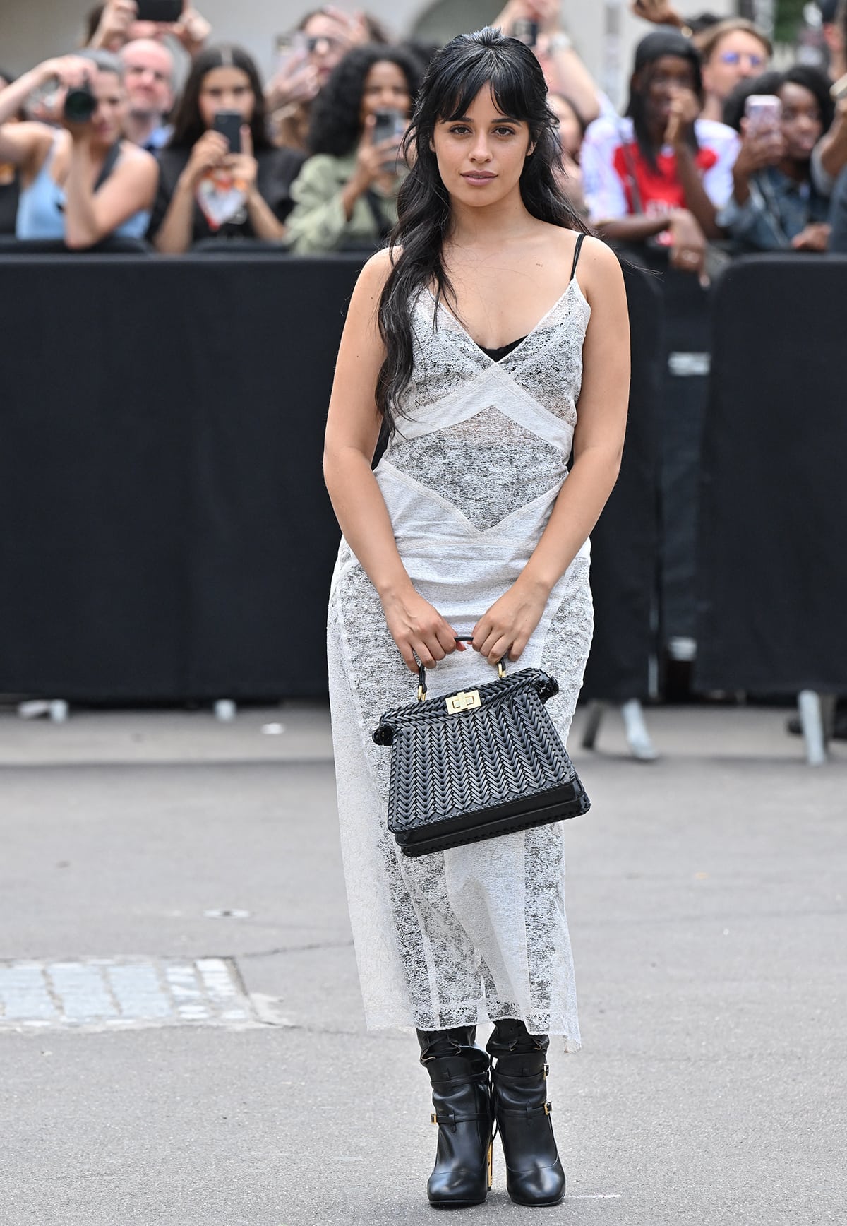 Camila Cabello contrasts her lovely white sheer lace Fendi dress with edgy black leather knee-high boots at the Fendi Couture Fall 2024 presentation during Haute Couture Fashion Week in Paris on July 6, 2023