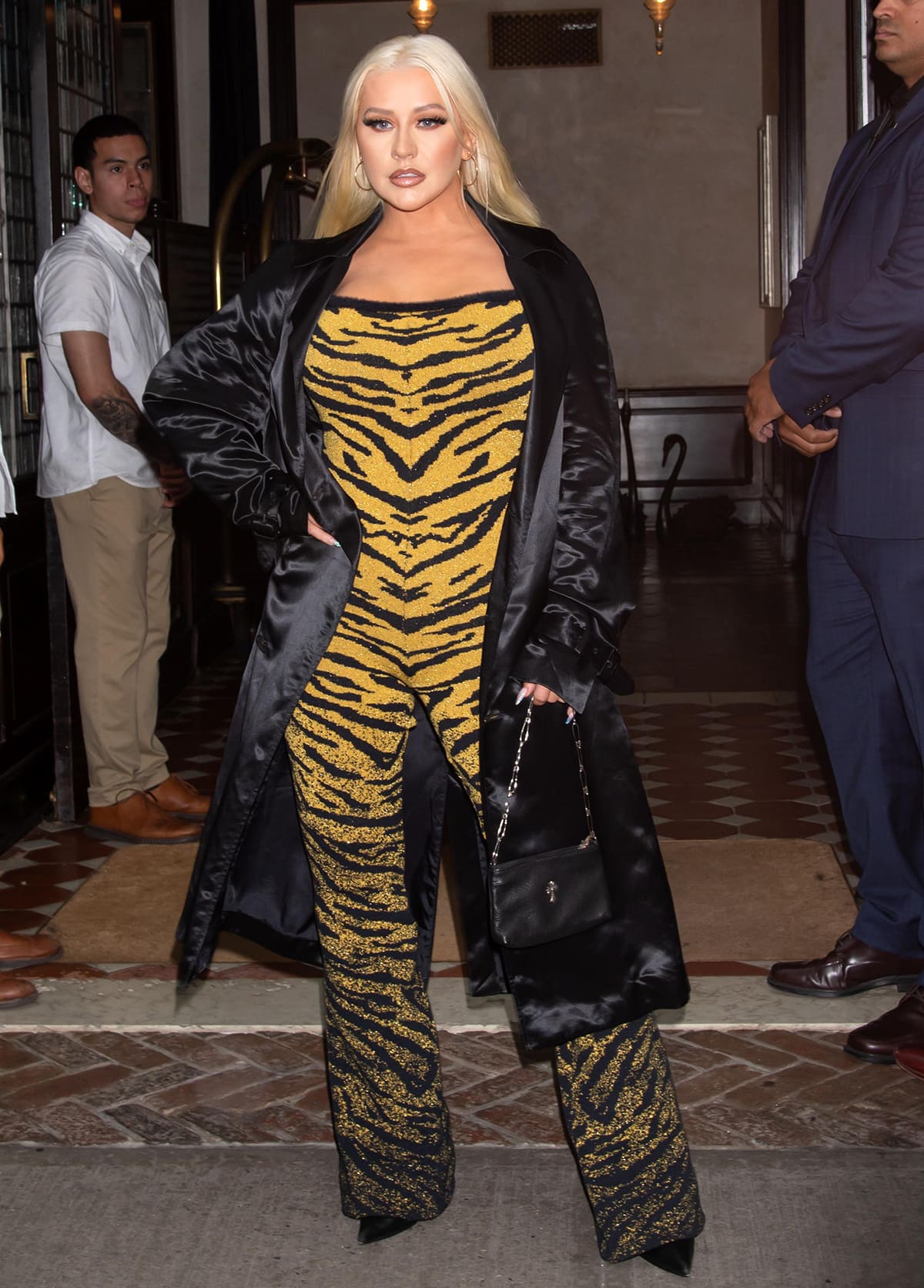 Christina Aguilera steps out to see the Lion King musical in a sequined black-and-gold tiger-striped catsuit