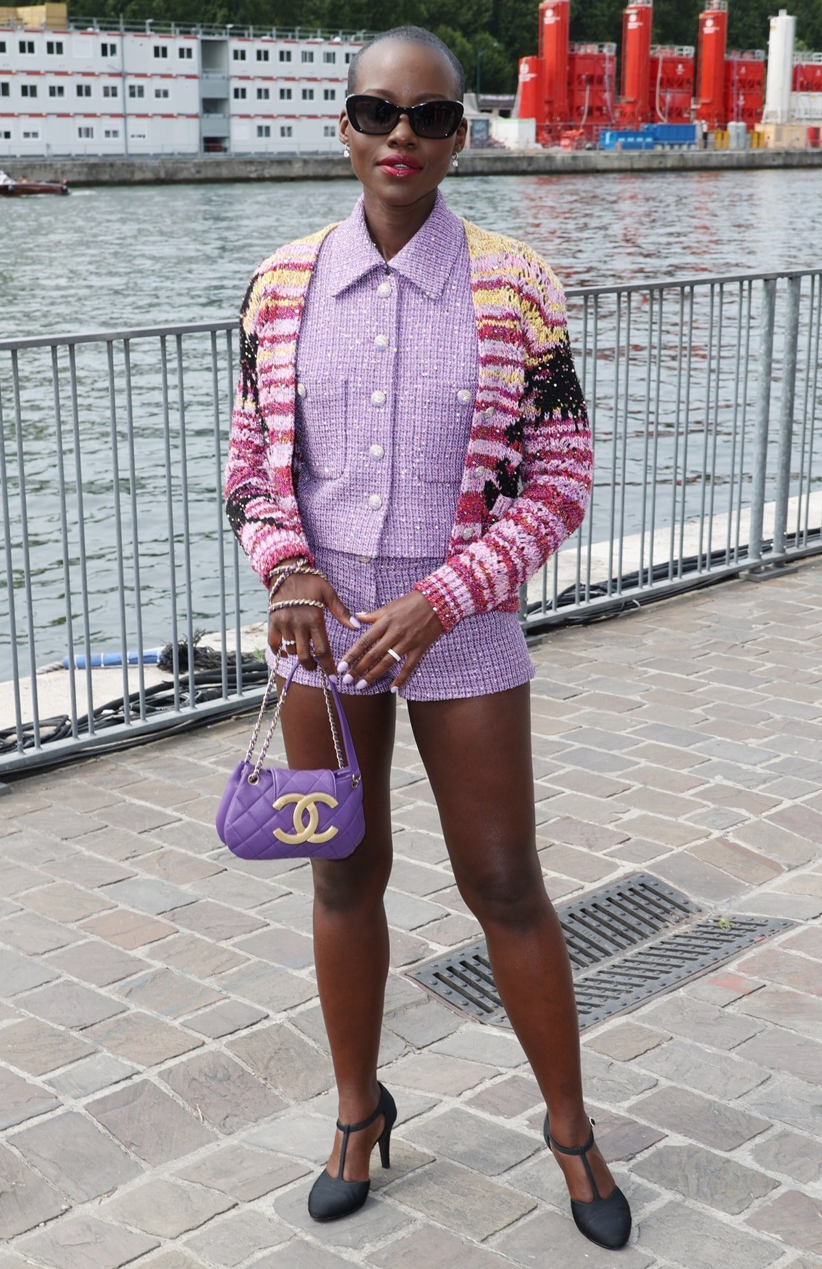 Lupita Nyong'o looked stunning and chic in an elegant lavender tweed ensemble from Chanel, which consisted of a matching vest and shorts set, at the Chanel Haute Couture Fall/Winter 2023/2024 show