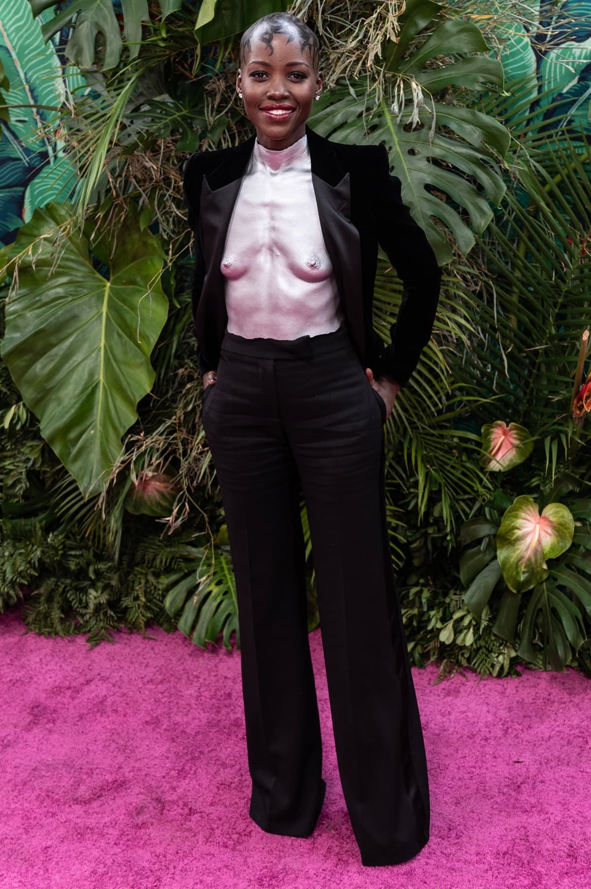 Lupita Nyong'o made a stunning appearance at the 76th Annual Tony Awards on June 11, 2023, at United Palace Theater in New York City, grabbing everyone's attention in a black velvet suit jacket and trousers, complemented by a custom-made metallic breastplate crafted by Pakistani artist Misha Japanwala