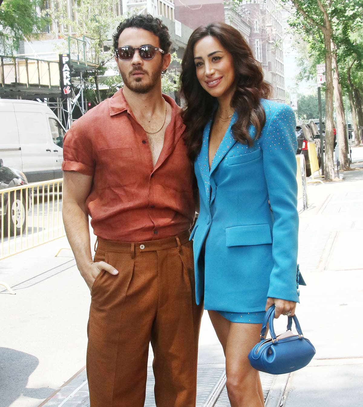 Danielle Jonas carries a blue Yuzefi mini bag and finishes off her outfit with Miu Miu heels