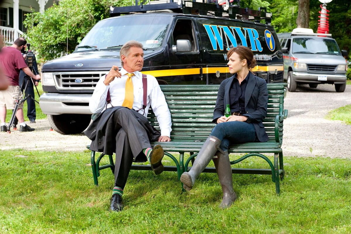 Rachel McAdams grounds Becky Fuller’s high-pressure newsroom look with classic black Hunter Original Tall rain boots, a practical counterpoint to her otherwise polished on-screen wardrobe