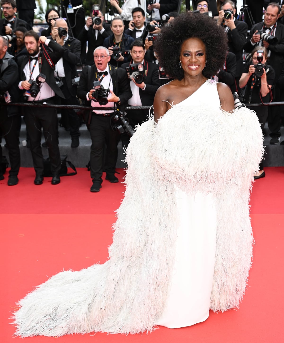 At the 2023 Cannes Film Festival in Cannes, Viola Davis looked stunning in a white gown paired with a captivating feathered coat, both from Valentino couture