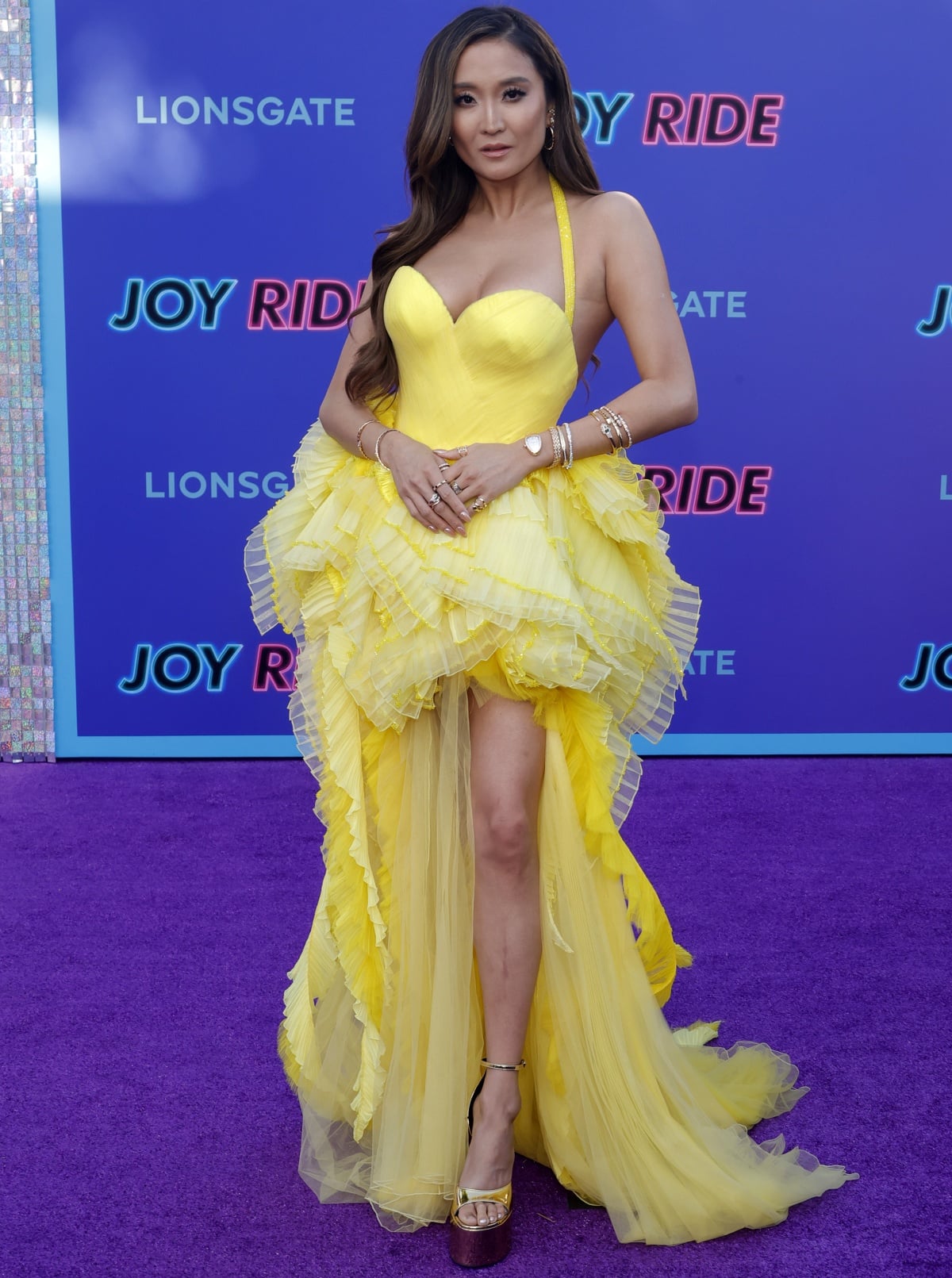 Ashley Park brightening up the carpet in a yellow Atelier Versace Spring 2021 dress at the premiere of Joy Ride