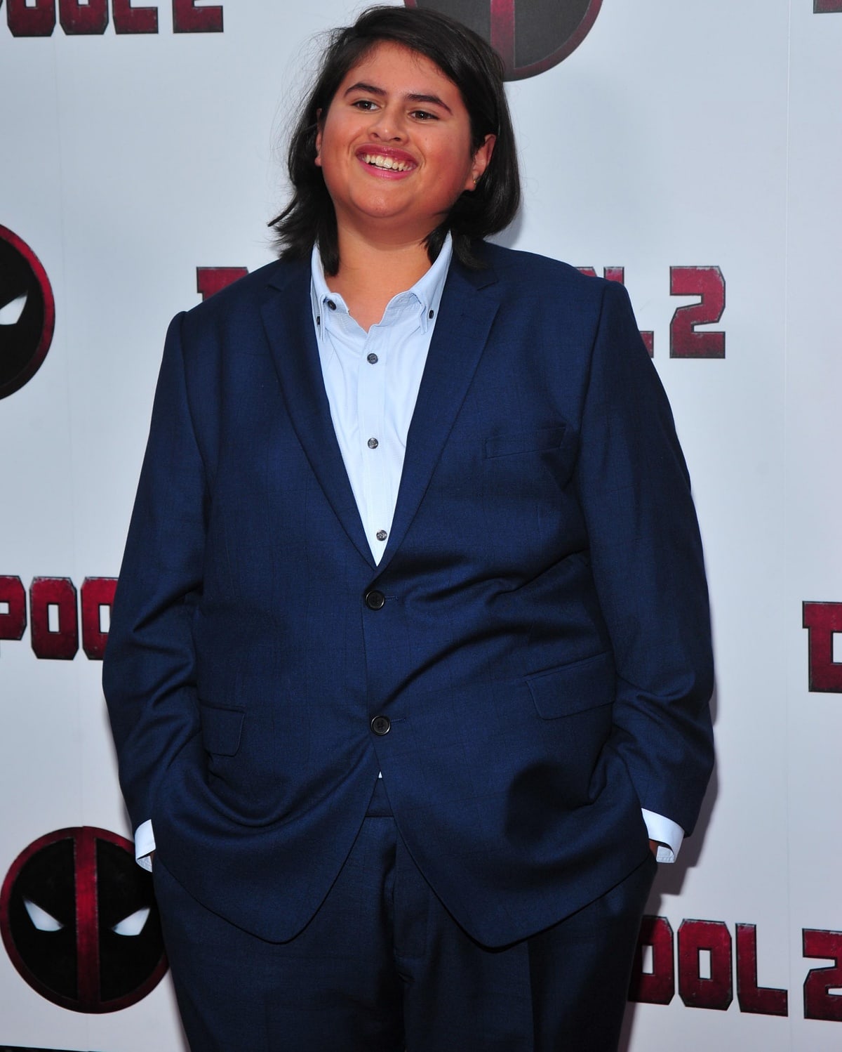 Julian Dennison, born on October 26, 2002, is a New Zealand actor who debuted in the 2013 film "Shopping," winning the English Film and Television Award for Best Supporting Actor, and is best known for his roles in "Hunt for the Wilderpeople" (2016), the highest-grossing New Zealand film in history, "Deadpool 2" (2018), "The Christmas Chronicles 2," and "Godzilla vs. Kong" (2021)