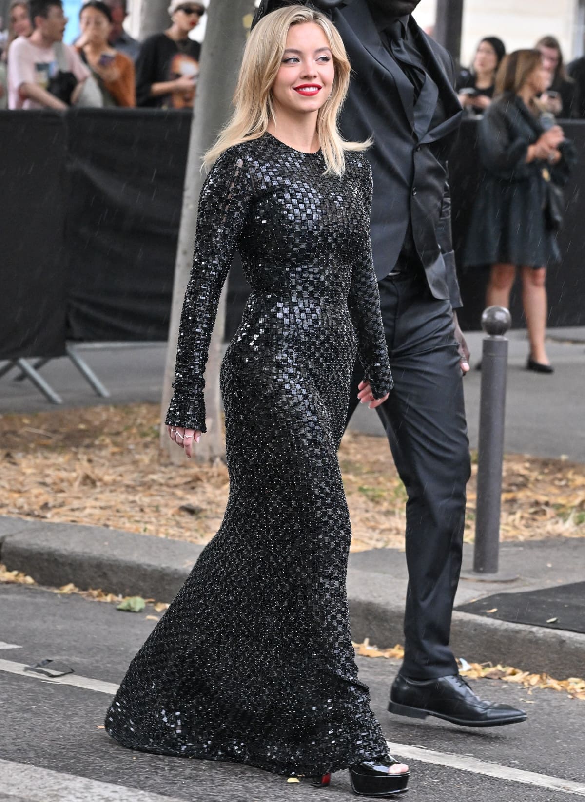 Sydney Sweeney arriving at the venue while strutting in her black platform heels that complemented her Giorgio Armani gown and gave her a stylish boost