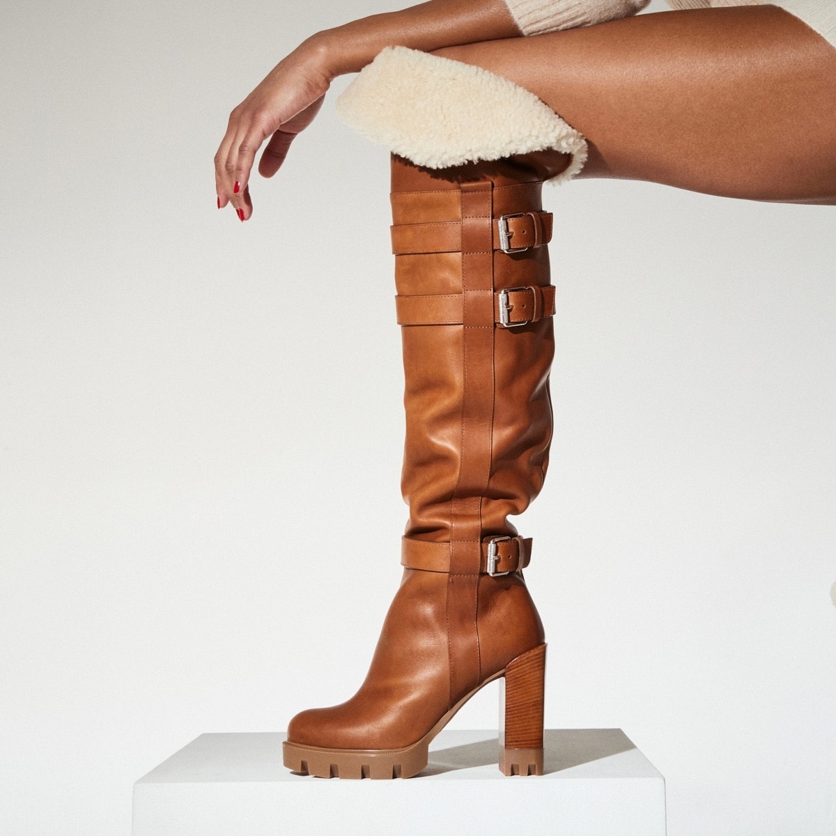 This luxurious boot is meticulously crafted from Terra brown waxed leather, beautifully complemented by white wool encasing the leg, creating a sophisticated and stylish look
