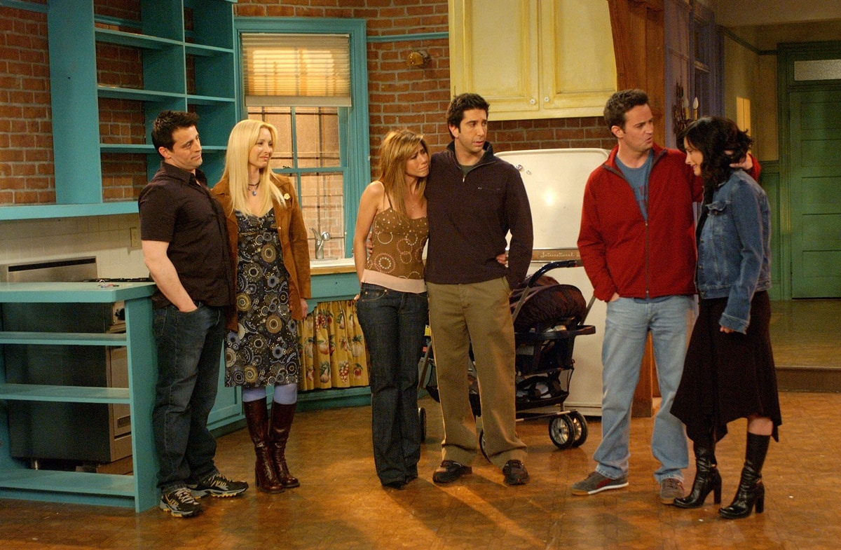 The cast of Friends shares a final moment in Monica's apartment during the emotional series finale