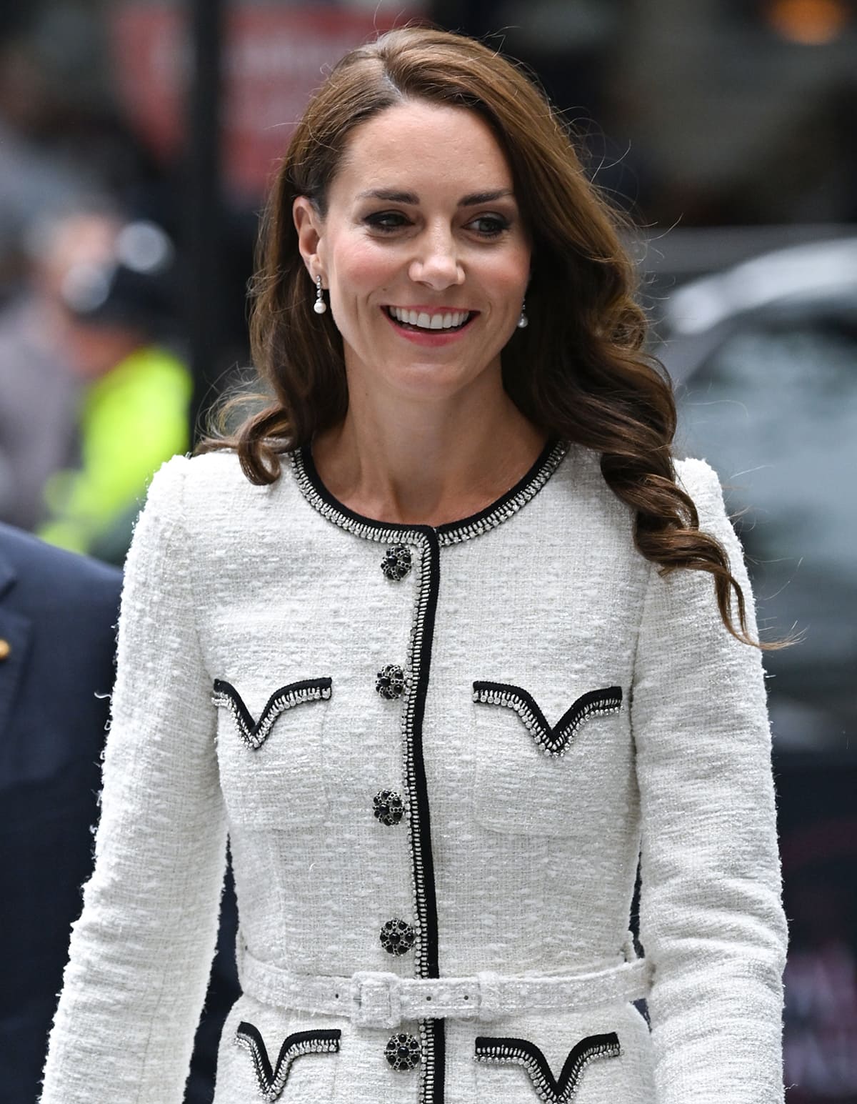 Kate Middleton wears side-parted curls with peachy blush and pink lip color
