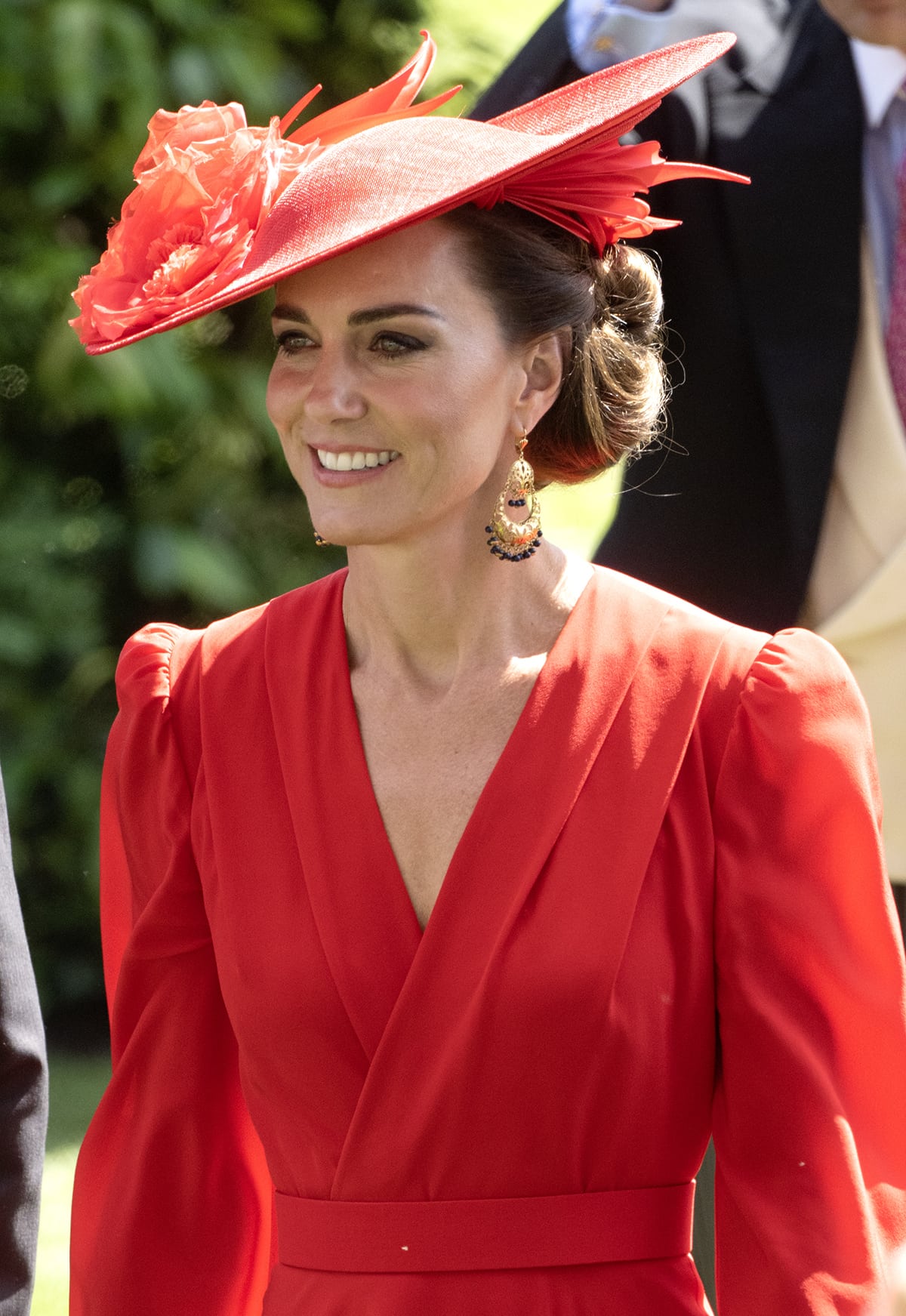Kate Middleton completes her fiery red look with a custom-made red hat by Philip Treacy