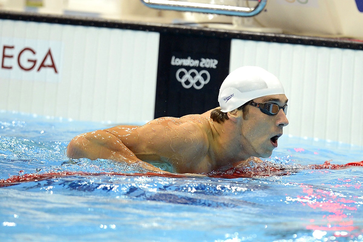 Michael Phelps, pictured competing in the 100m butterfly event during 2012 London Olympic Games, started swimming at 7 years old