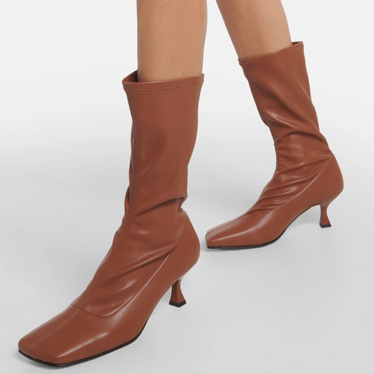 These Souliers Martinez Lola faux leather ankle boots feature a squared toe and stable, comfortable heels that give them an intense yet feminine look