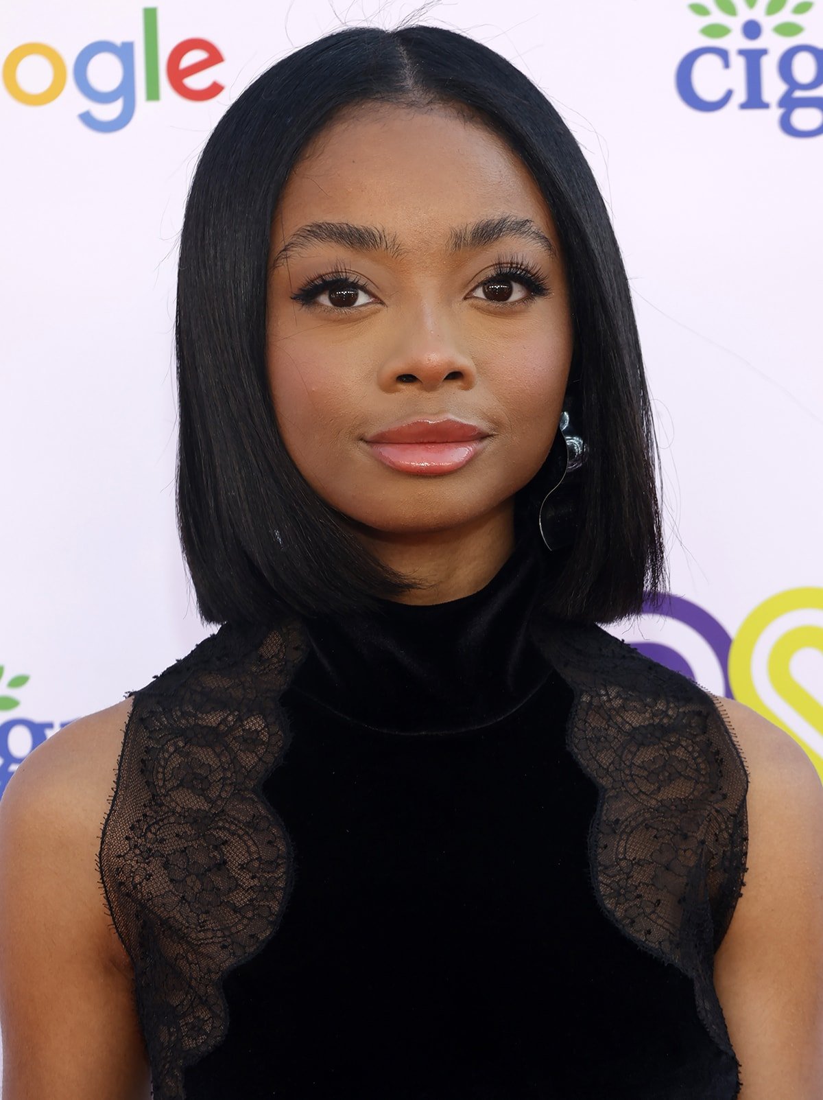 Skai Jackson wears a sleek straight bob hairstyle and accentuates her features with feathery eyelashes and pink lip gloss