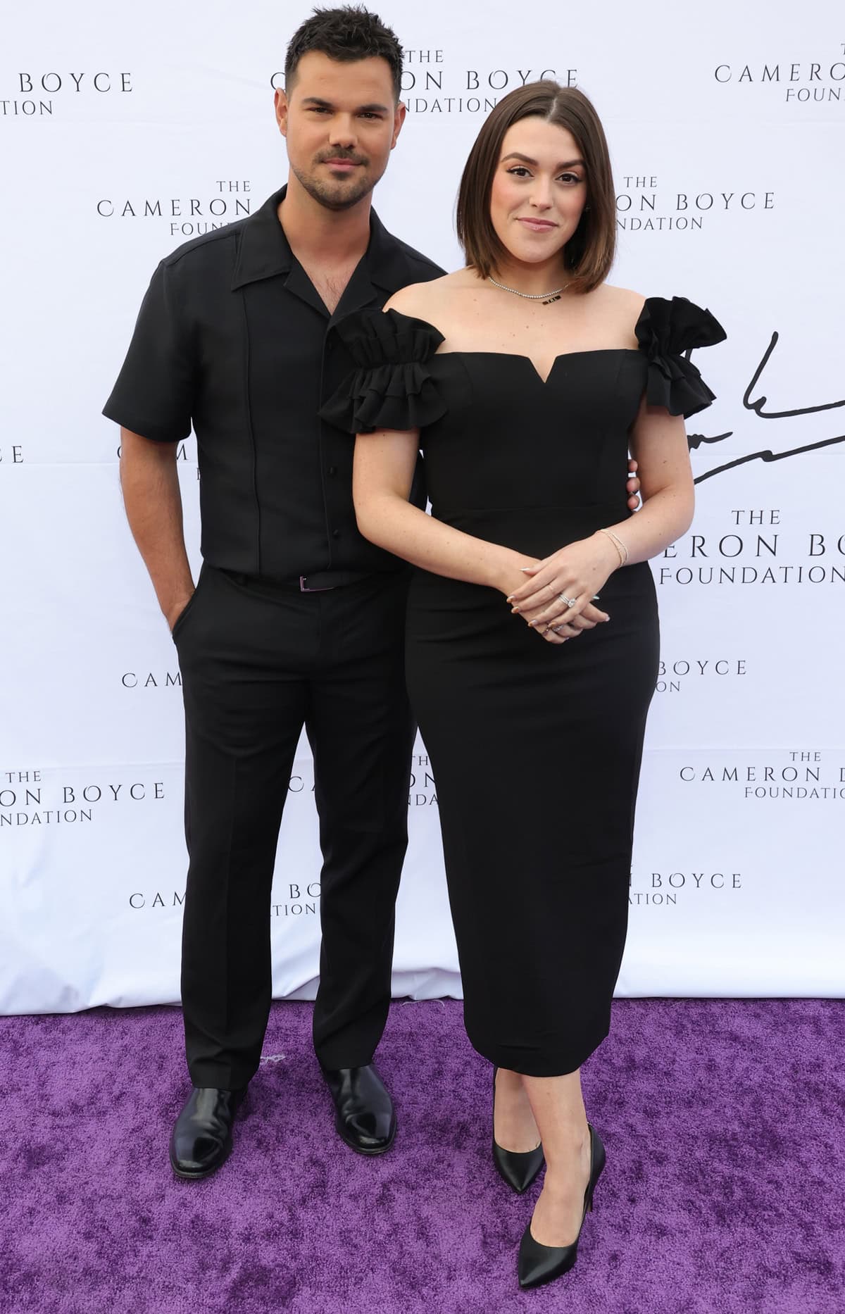 Taylor and Tay Lautner nailed monochromatic elegance in matching black ensembles, with Tay elevating her sleek midi dress in Jeffrey Campbell Formation pointed-toe pumps and Taylor in classic leather loafers at the 2024 Cam for a Cause Gala