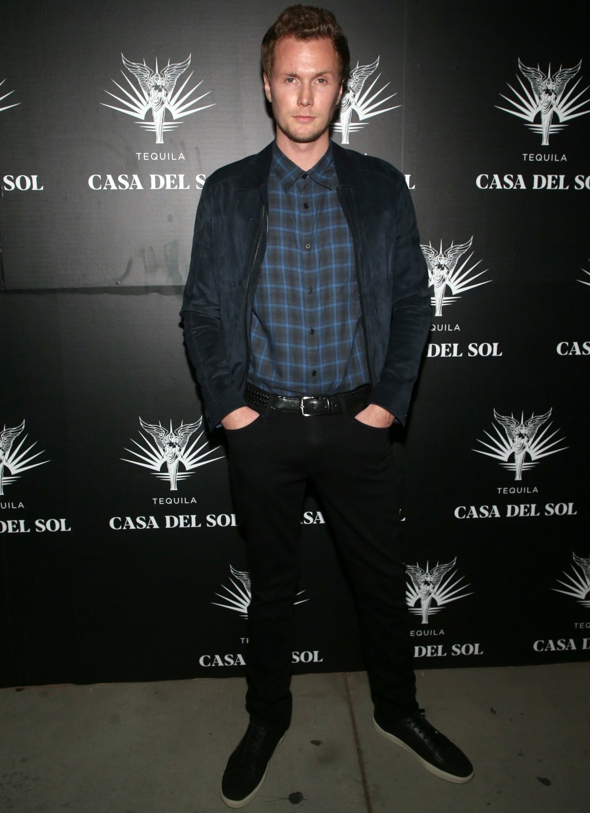 Barron Hilton II keeps it casual in a blue plaid shirt, black jeans, and sleek black sneakers at Brian Bowen Smith’s Drivebys book launch and gallery viewing, presented by Casa Del Sol Tequila in Los Angeles on October 21, 2021