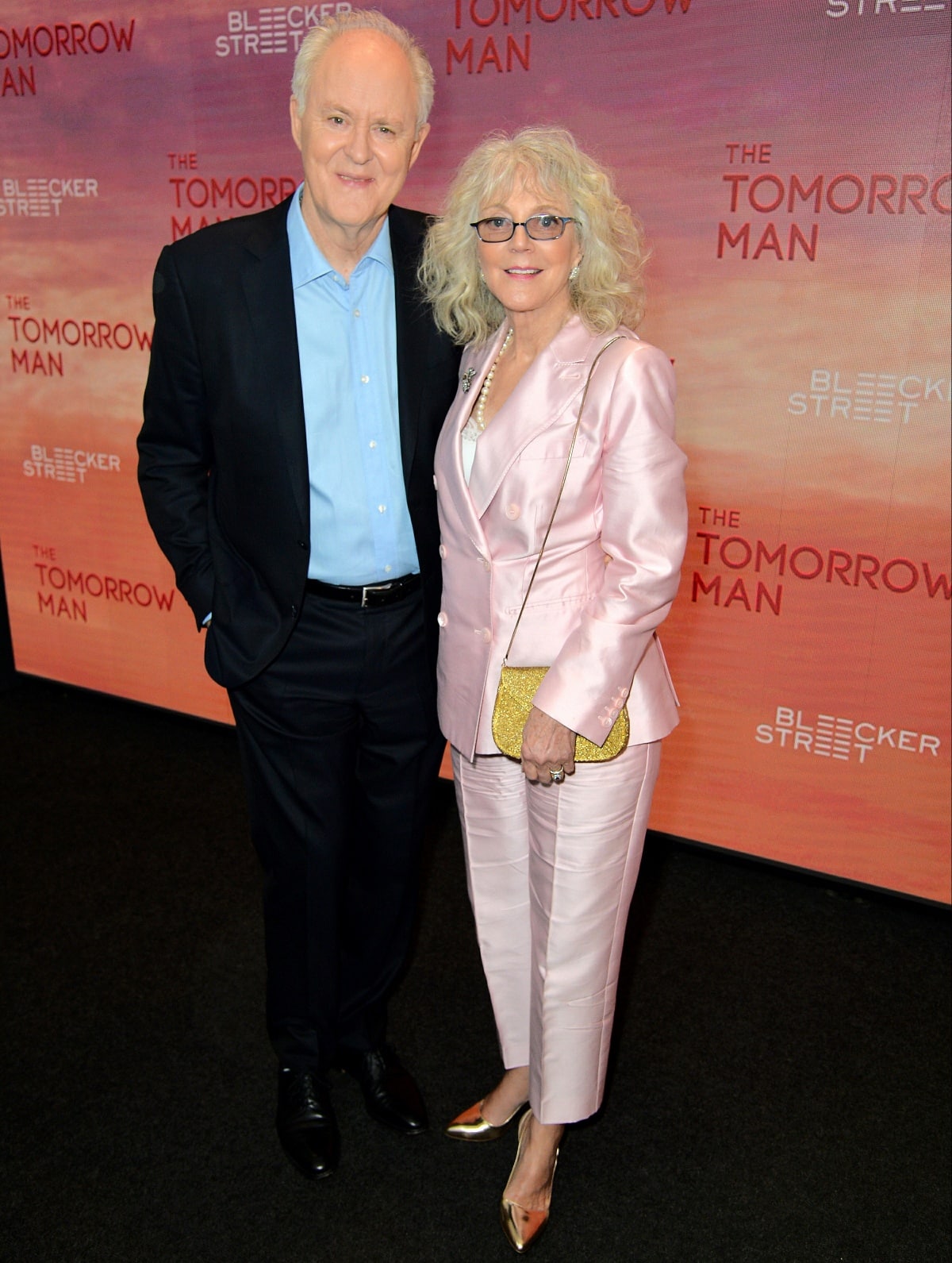 Blythe Danner stood out in a blush pink silk suit and gold pointed-toe heels, visibly shorter than her The Tomorrow Man co-star John Lithgow, who towered beside her in classic black dress shoes