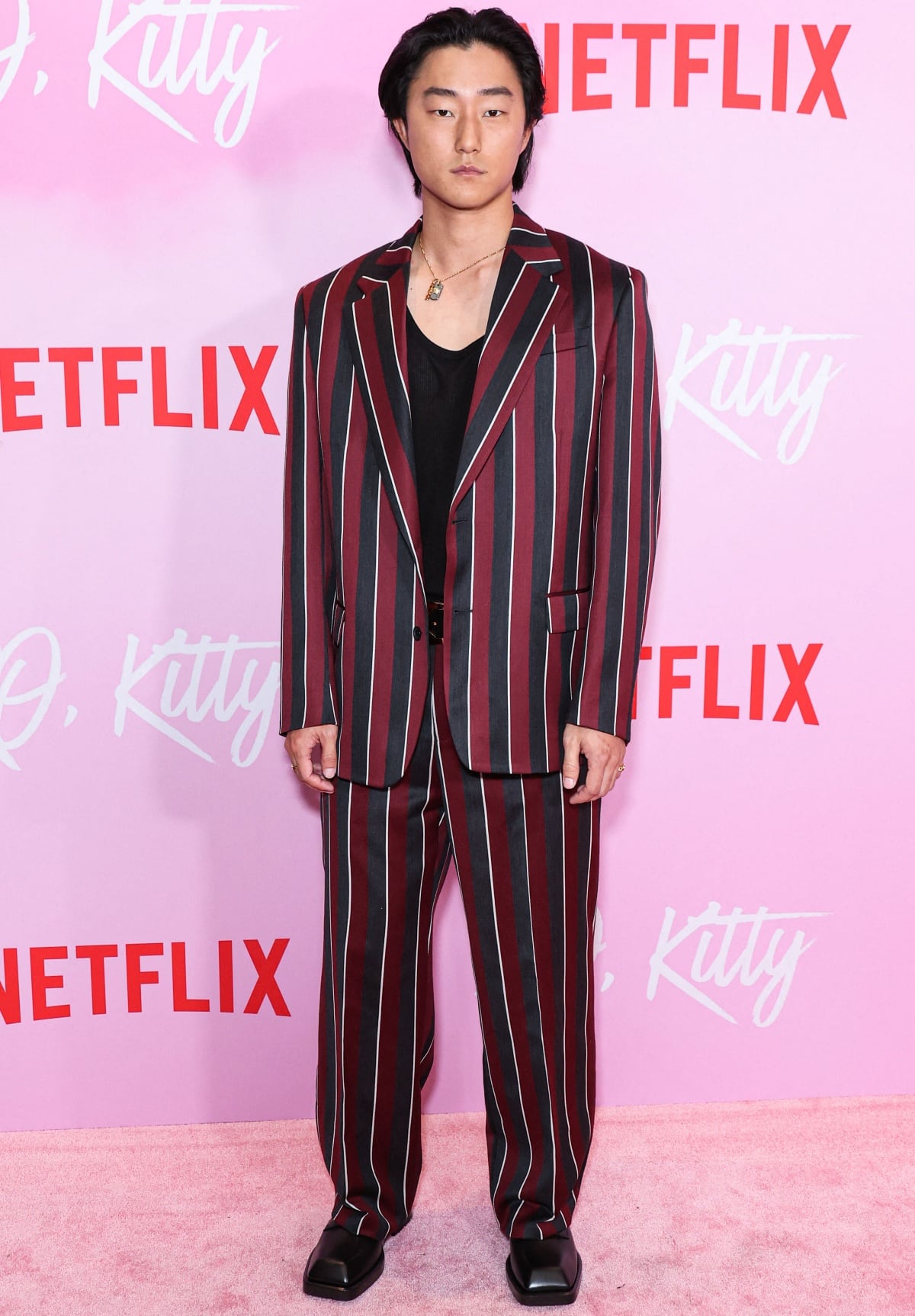 Peter Thurnwald wearing a striped suit and black dress shoes at the Los Angeles premiere event of Netflix’s XO, Kitty Season 1