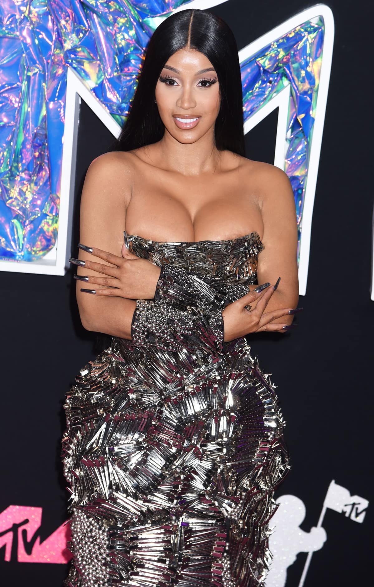 A closer look at Cardi B's dress revealed an intricate design crafted from hundreds of silver hair clips arranged in captivating swirls and fan-like patterns