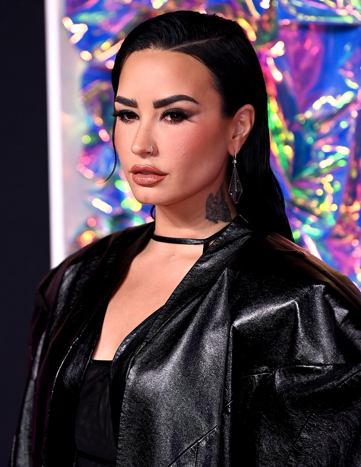 Demi Lovato completes her gothic, rock-chic look with sleek tresses, smokey eyes, and nude lipstick